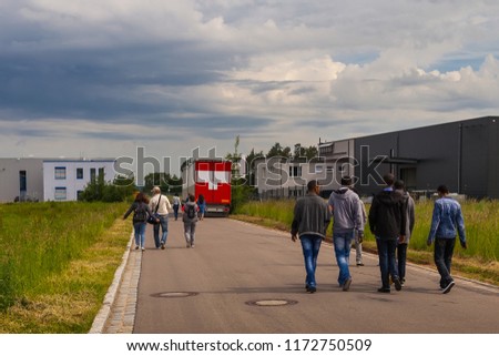 A group of people, white and black refugees are on the road