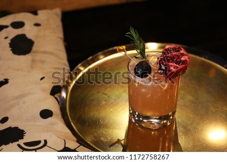 Pomegranate, grape cocktail on metal