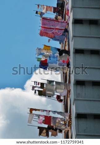 Drying washing outside the apartment blocks of a high rise building, Singapore