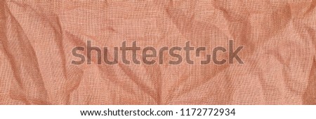 Trendy calming coral colour linen flax cloth texture. Wrinkled linen fabric background. Linen fabric texture. Stone washed  light orange pure linen background. Banner.