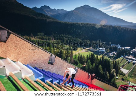 Athlete running on the top of ski jumping hills