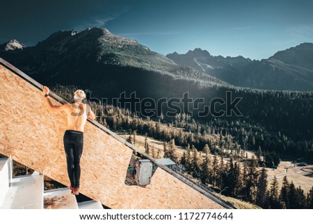Athlete looking at beautiful big mountains, Thinking, inspirational sport concept photo