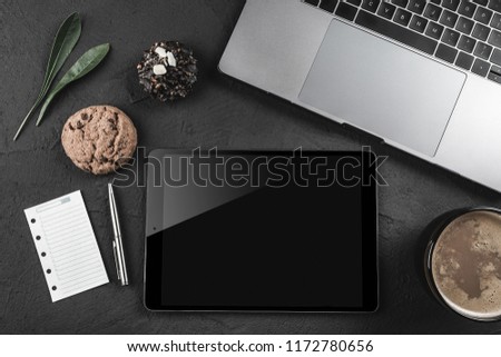 Top view mockup image of keyboard laptop, tablet pc or ipad, a page on the note book and coffee cup on stone table