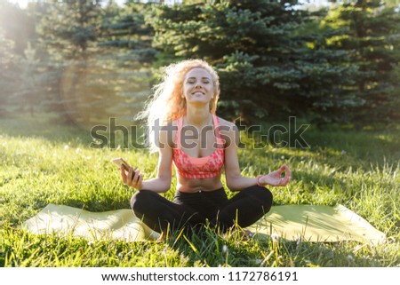 Picture of young athlete woman practicing yoga on rug
