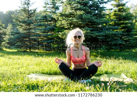 Image of young athlete practicing yoga on rug
