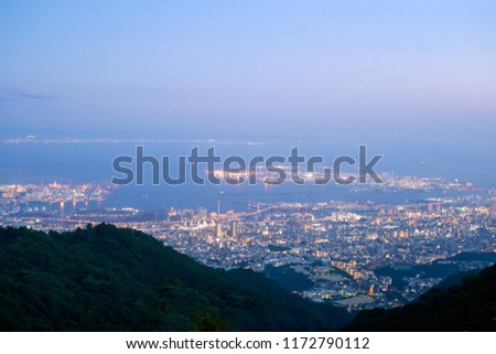 Lights from Kobe and Rokko Michi on the edge of Osaka Bay just after sunset