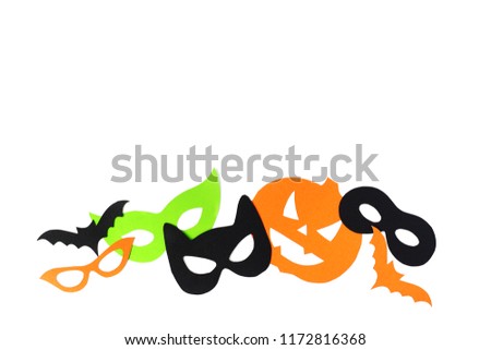 Halloween. The  masks from paper on a white background which are cut out. Children's hands.