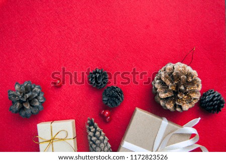 festive christmas red background top view with cones