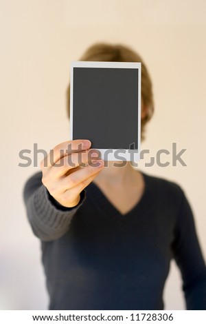 woman holding empty card in front, shallow DOF