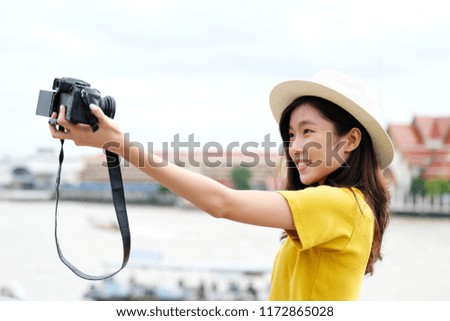 Young asian female traveler taking selfie photo in city outdoors background, Travel blogger, vlog concept
