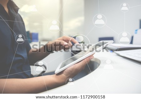 Business man is using the tablet with human icon for technology to connect to other people concept