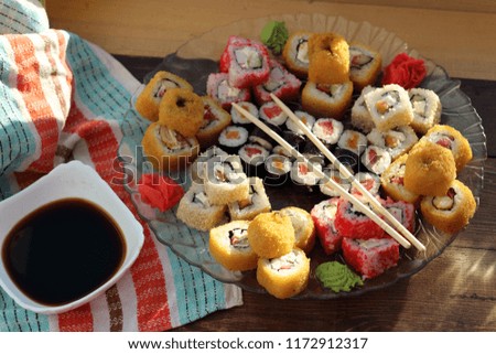 Delicious and appetizing still life with Japanese rolls. A hearty and bright dish of seafood and rice