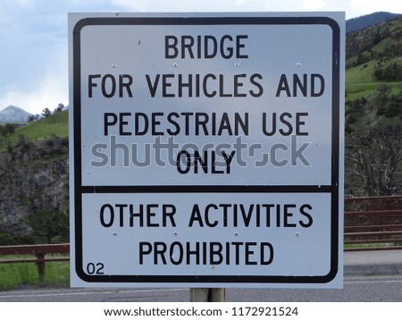 A  bridge sign prohibiting any activity other than vehicles and pedestrians 