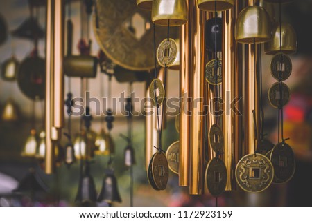 Garden decoration, wind chimes hanging in a blooming tree, bamboo chimes on a cherry tree in garden Royalty-Free Stock Photo #1172923159