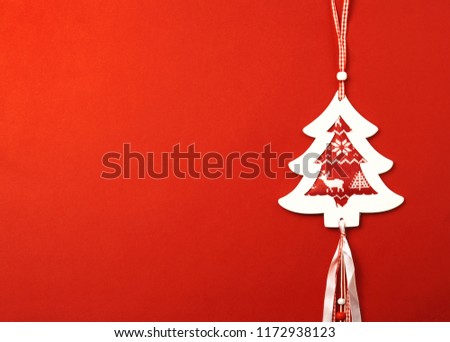 Christmas frame-postcard. Christmas decorative tree on a red background located on the right. A ready-made idea for your text and design