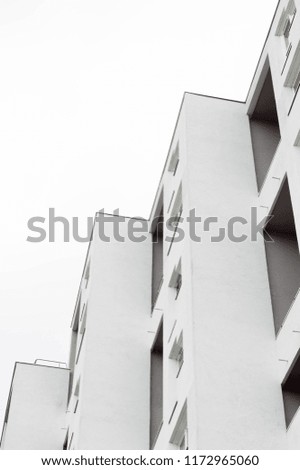 Minimalist and abstract shape of a white residential building in the sky.