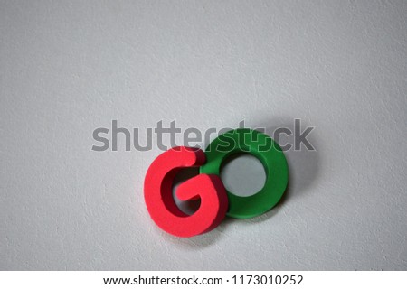 Word GO from colorful 3D foam letters on white background