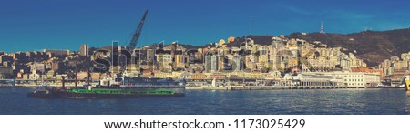 Image of  old port of Genova city with cargo boats with crane at quay, Italy
