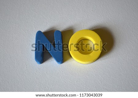 Word NO from colorful 3D foam letters on white background