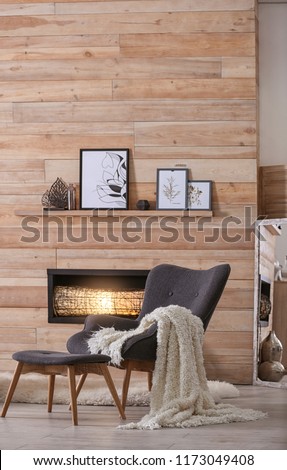 Cozy living room interior with comfortable furniture and decorative fireplace