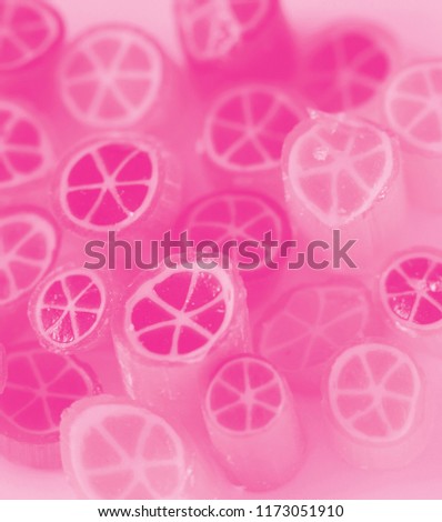 Background of orange candies pink colour, closeup