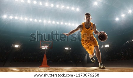 Basketball player dribbles Royalty-Free Stock Photo #1173076258