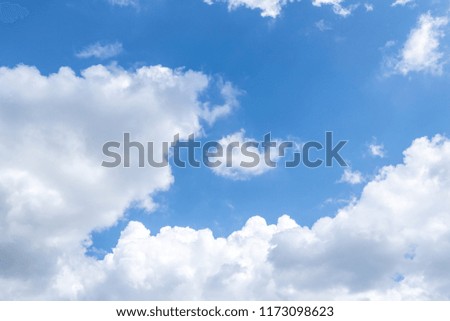Fluffy white clouds and background is blue sky.