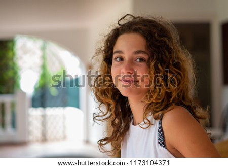 Portrait of a 10 year old girl, blonde and with curls