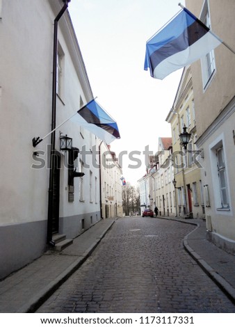 Estonian flags are on facade of a building. Historyan street