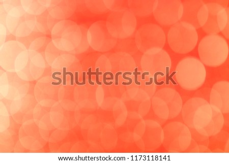 Abstract light yellow bokeh texture on blurred red background. Trendy Valentine decoration for wallpaper.
