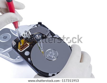 technician with open hard-disk and screwdriver in light background