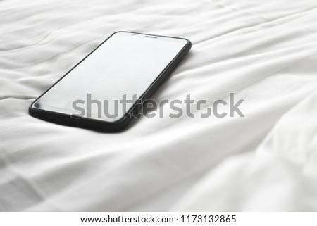 smartphone on bed,phone addict concept.