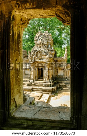 Looking through the silhouette of a window at Chau Say Tevoda Temple that’s part of the UNESCO Angkor Wat temples and ruins in Cambodia. Royalty-Free Stock Photo #1173160573