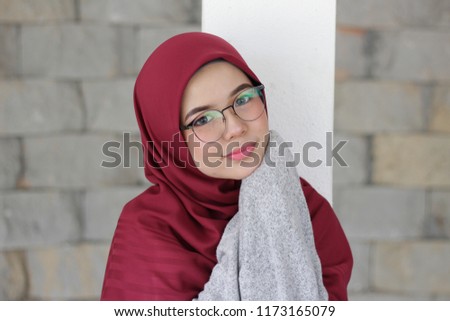 portrait of cute young hijab girl with expression on her face at the park around evening. Mood concept.