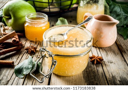 Homemade apple jam or sauce, with green apples and spices, wooden rustic background copy space  Royalty-Free Stock Photo #1173183838