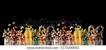 Mix Nuts in the glass on black background close up nuts pistachios almond cashew nuts peanut sunflower seeds Royalty-Free Stock Photo #1173200002