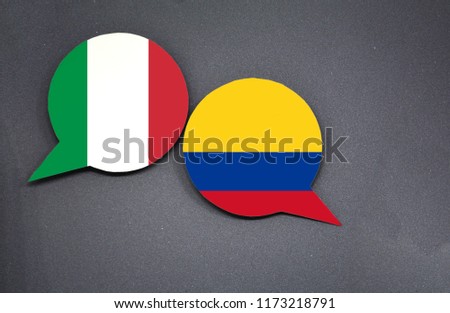 Italy and Colombia flags with two speech bubbles on dark gray background