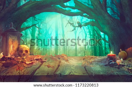 Halloween theme with pumpkins, skull and dark forest. Scary Halloween design on table