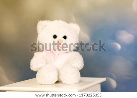 White teddy bear on a white table