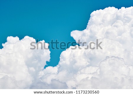Picture of magical clouds. White voluminous foamy air magic clouds in a bright blue sky. The background of a bright sky with clouds