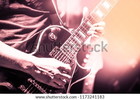 Guitarist on stage for background, soft and blur concept. Close up hand playing guitar. young musician playing guitar, live music background.Band performs on stage, rock music concert. Royalty-Free Stock Photo #1173241183