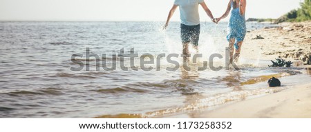 young couple is running on the water