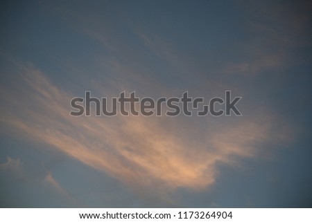 In this image the clouds and sky are dark red against the sunset background these skies are very beautiful their blue color is mixed with pink tones