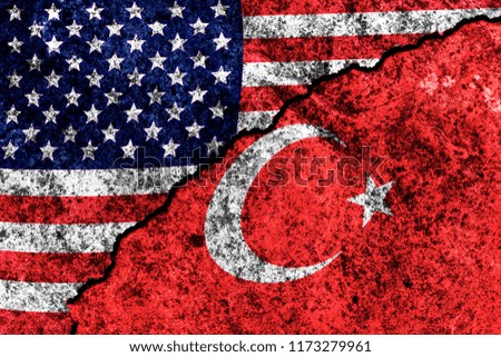 two flags of the USA and Turkey on a cracked concrete wall
