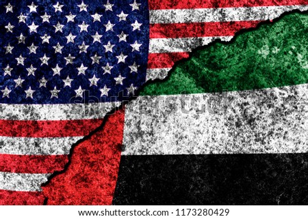 two flags of the USA and UAE on a cracked concrete wall
