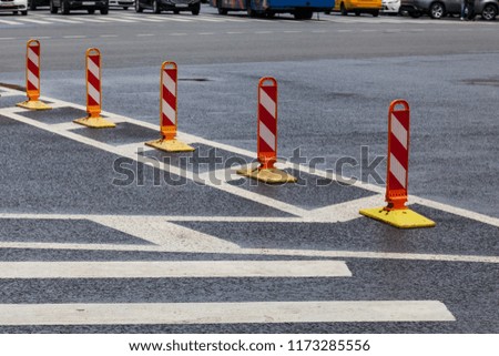 Traffic cones on asphalt road with white marking