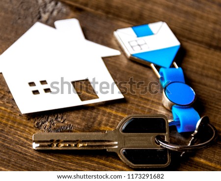 concept of buying house on wooden background close up.
