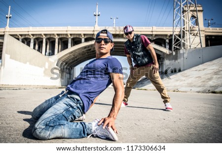 Breakdancers performing in a water duct