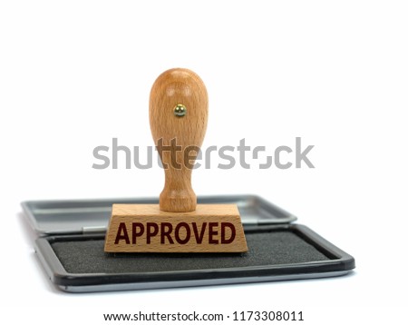 Wooden stamp with imprint "approved"  Royalty-Free Stock Photo #1173308011