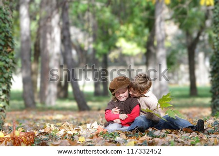 two young happy children - boy and girl - on natural autumn background